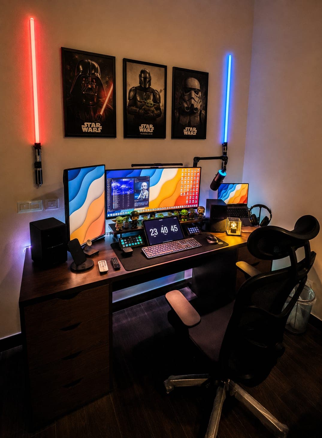 A finished home office with mounted monitors and framed art